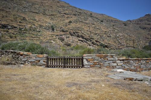 a stone fence and a stone wall in front of a mountain at Private Home 2' from the beach, Orkos Kea in Orkos