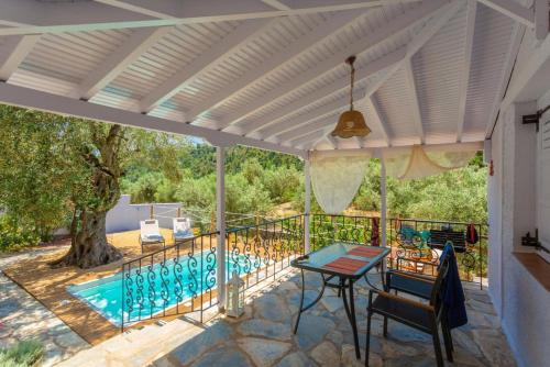 a patio with a table and a swimming pool at Neptune in Alonnisos Old Town