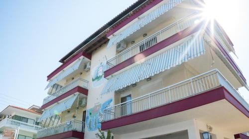 a building with colorful balconies on the side of it at Niki Apartments in Paralia Dionysiou