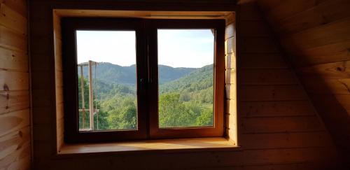 a window in a room with a view of mountains at Bacówka PTTK Jaworzec in Wetlina