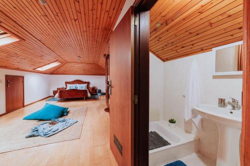 a bathroom with a tub and a sink in a room at Vila Mar Apartment in Ponta do Sol