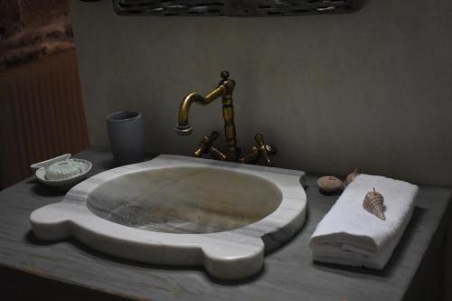 a bathroom sink with a marble counter top at Private Home 2' from the beach, Orkos Kea in Orkos