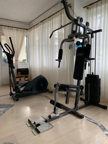 a gym with a treadmill and a exercise bike at Niki Apartments in Paralia Dionysiou