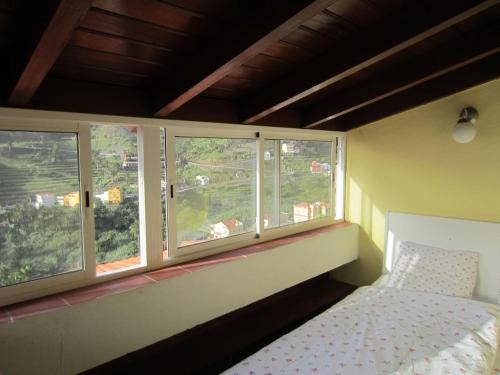a bedroom with two windows and a bed in it at Finca La Ladera in Valle Gran Rey