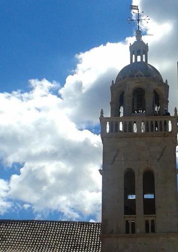 a tower with a weather vane on top of a building at Apartments Milion in Korčula