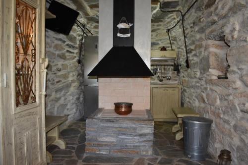 a kitchen with a brick stove in a room at Private Home 2' from the beach, Orkos Kea in Orkos