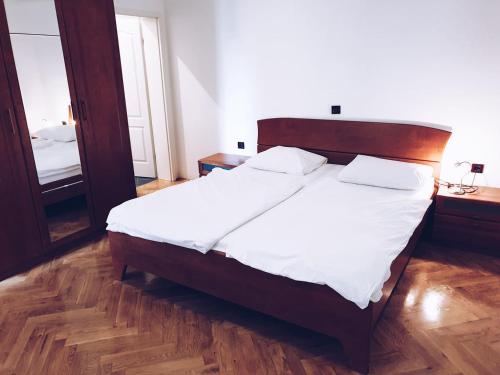 a bedroom with a large bed and a mirror at Villa Dubravka in Lopar