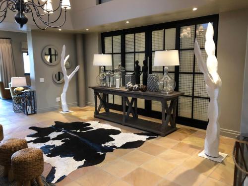 a living room with a table and some white sculptures at Santé Wellness Retreat & Spa in Paarl