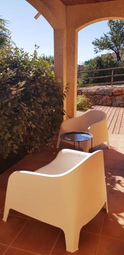 two white chairs and a table on a patio at La villa marquesa in Fitou