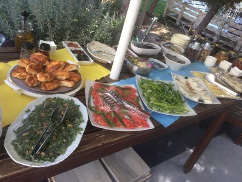 a table with many plates of food on it at Ege Han Hotel in Bozcaada
