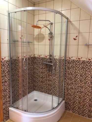 a shower with a glass enclosure in a bathroom at MKA Life in Ventspils