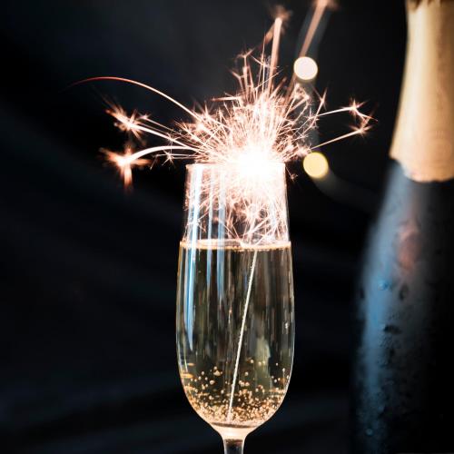 a sparkler in a glass with a bottle of wine at Douro Palace Hotel Resort & SPA in Baião
