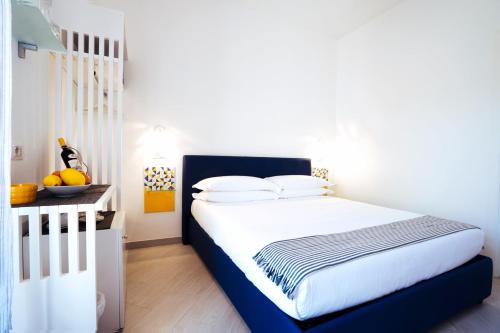 a bedroom with a bed with a blue headboard at Suite Lia - Private Room with garden and tub close to Villa Eva e Cimbrone, Ravello in Ravello
