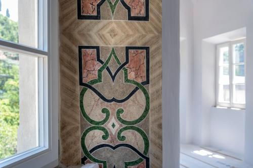 a custom stained glass door with a green design on a wall at Castel Hörtenberg in Bolzano