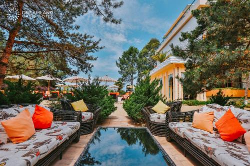 a patio with couches and a pool of water at Dreamland Oasis Hotel Chakvi in Chakvi