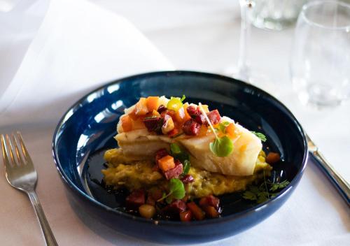 a blue plate with food on a table at Quality Hotel Florø in Florø