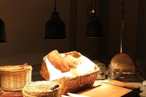 a table with baskets of bread on a table at Rosersbergs Slottshotell in Rosersberg