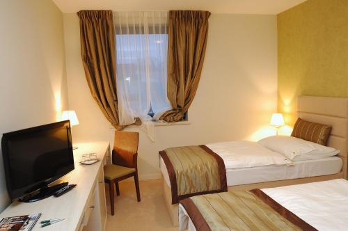 Postel nebo postele na pokoji v ubytování Hotel Predium