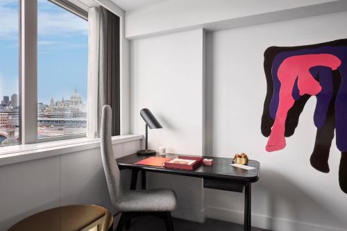 a room with a desk and a window at Sea Containers London in London
