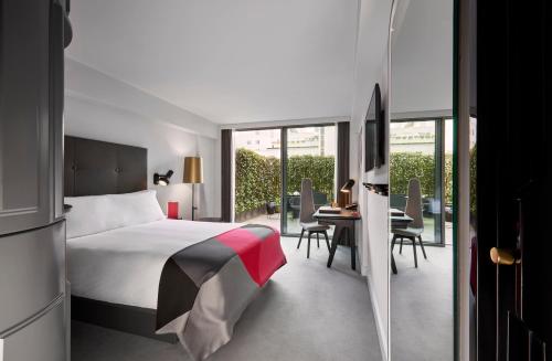 a bedroom with a bed and a table and chairs at Sea Containers London in London