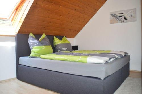 a bed with colorful pillows on it in a room at Ferienwohnung Sonnenblick in Albstadt