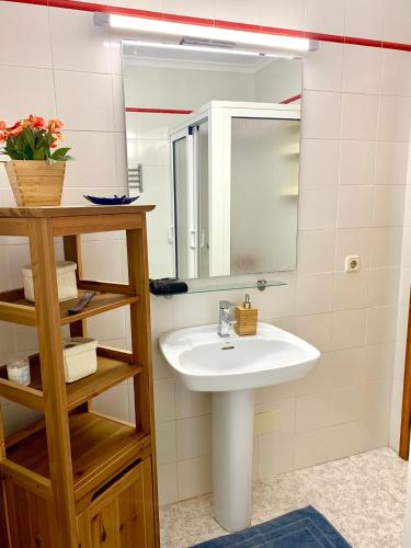a bathroom with a sink and a mirror at La Playa in Órzola