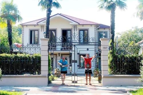 two people standing in front of a house at Kobuleti VILLA SKAZOCNI DVORIK VIP in K'obulet'i
