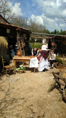 a group of people sitting around a wooden table at Petalo Rosso b&b in Lenola