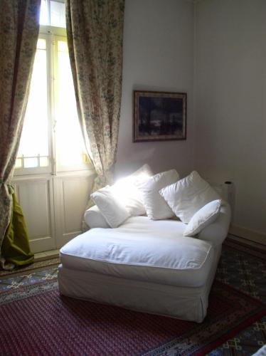 a white couch in a room with a window at La Maison de Sophie in Nîmes