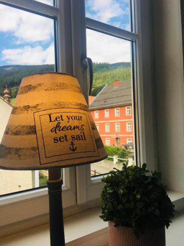 a lamp with a sign on it sitting next to a window at Alpenaquarium Grüblsee - FEWO Elfi in Vordernberg
