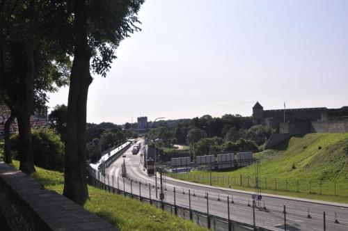 a view of a road with a castle in the background at Prestige Apartment in Narva