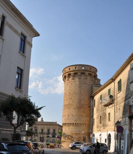 a tall brick tower sitting next to a building at La Torre in Vasto