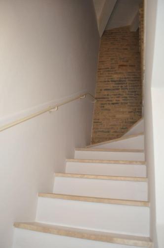 a staircase in a room with a brick wall at La Torre in Vasto