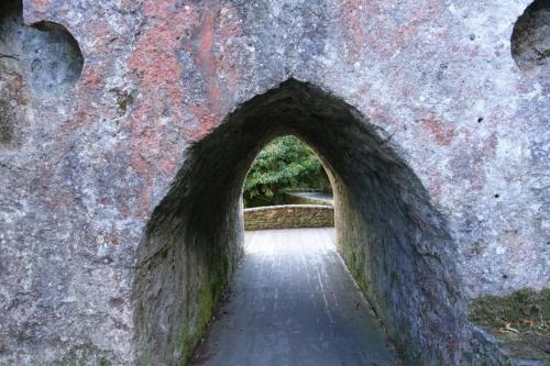 an archway in a stone wall with a pathway at The Downshire Arms Apartments Hilltown in Newry