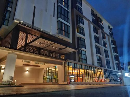 a large building with a balcony in front of it at ABIZZ Hotel Lampang Airport in Lampang