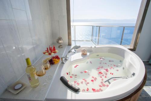 ein Badezimmer mit einer Badewanne mit Herzstücken in der Unterkunft Fener Hotel Café & Kahvalti in Cesme