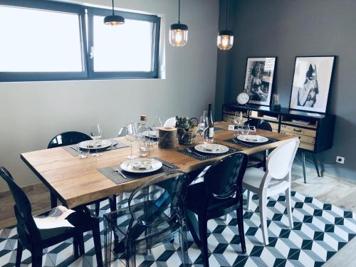 a dining room with a wooden table and chairs at Gîte Wellness Le Six H in Andolsheim