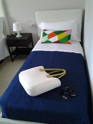 a hotel room with a bed with a blue comforter at Appartamento Galeotti 18 in Gubbio