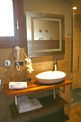 a bathroom with a sink and a mirror at Hotel Castillo de Alquézar in Alquézar