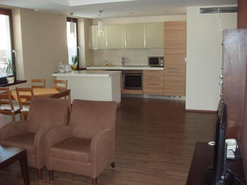 a kitchen and dining room with a table and chairs at Hotel Predium in Vráble