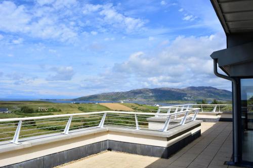 a balcony with a view of the mountains at Property 260 - Moyard in Moyard