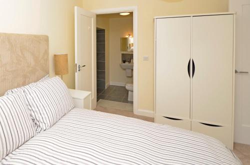 a bedroom with a bed and a closet and a bathroom at Property 260 - Moyard in Moyard