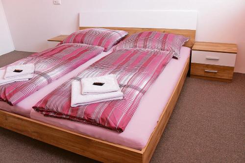 a bedroom with two beds with towels on them at Gasthof-Cafe-Risano in Haslach an der Mühl