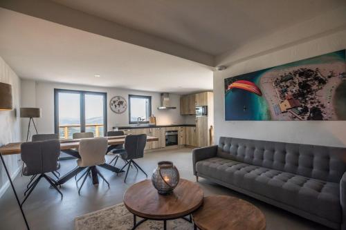 a living room with a couch and a table at ParaLodge in Saint-Vincent-les-Forts