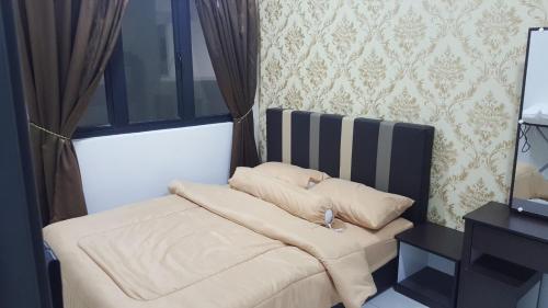 a bed with two pillows on it next to a window at DREAM HOME @ Emira Residence, Section 13 Shah Alam in Shah Alam