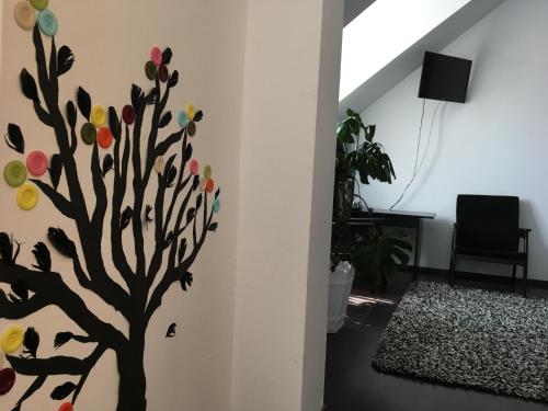 a tree mural on a wall in a living room at Pensiunea Michael's House in Rupea