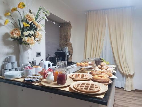 a table with breakfast foods on it in a kitchen at Residenza Vecchi Tempi in Vibo Valentia