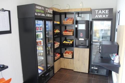a store with a refrigerator with food inside of it at ibis budget Antwerpen Port in Antwerp