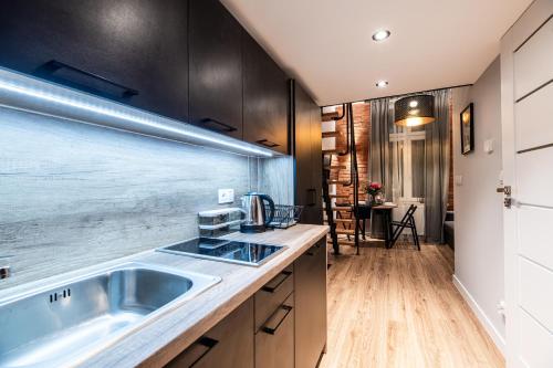 a kitchen with a sink and a counter top at Lubomirskiego 23 Residence - great location, 10 min to Main Square by foot, right next to Main Rail and Bus Station in Krakow