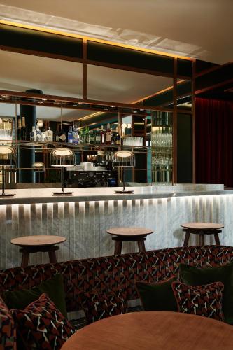 a restaurant with tables and a bar at Hôtel Le Ballu in Paris